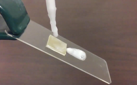 A drop of shampoo slides off a piece of plastic treated with the new coating. (Image: Ohio State University)